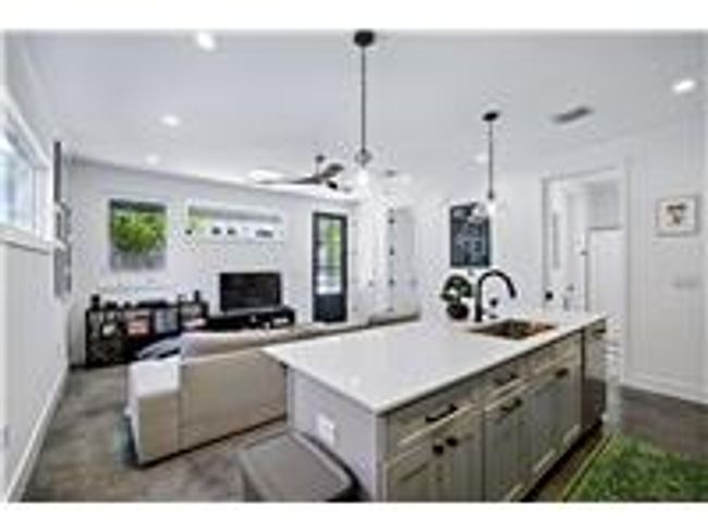 Kitchen featuring gray cabinets, concrete flooring | Image 7