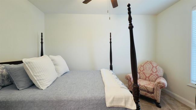 Bedroom with carpet flooring, multiple windows, and ceiling fan | Image 11