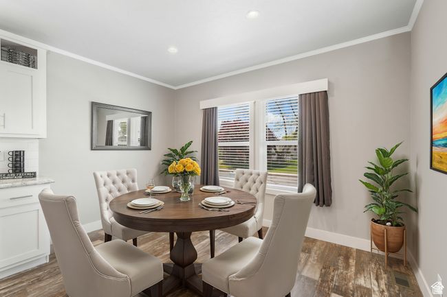 Dining space with baseboards, crown molding, dark wood-style floors, and recessed lighting | Image 6