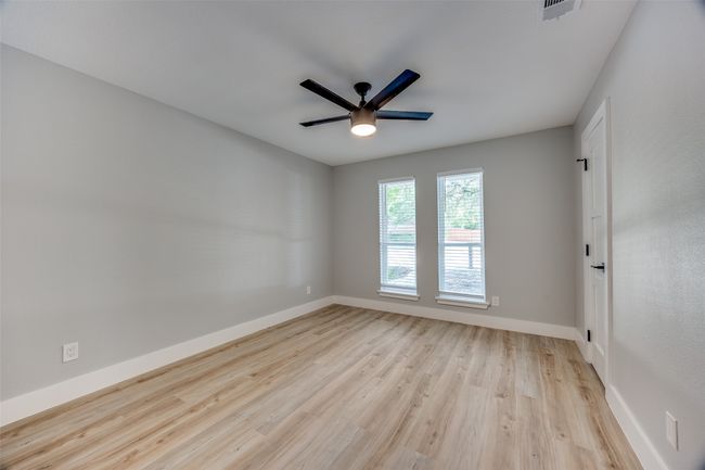 Spare room with ceiling fan and wood finished floors | Image 27