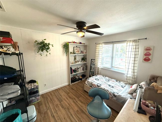 Bedroom featuring wood finished floors, a textured ceiling, and ceiling fan | Image 21