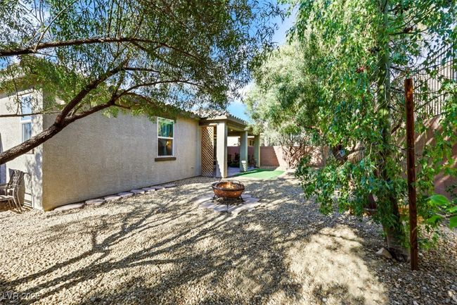 View of yard with an outdoor fire pit and a fenced backyard | Image 37