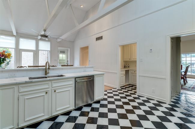 Kitchen with dishwasher, a sink, a ceiling fan, beamed ceiling, and high vaulted ceiling | Image 10