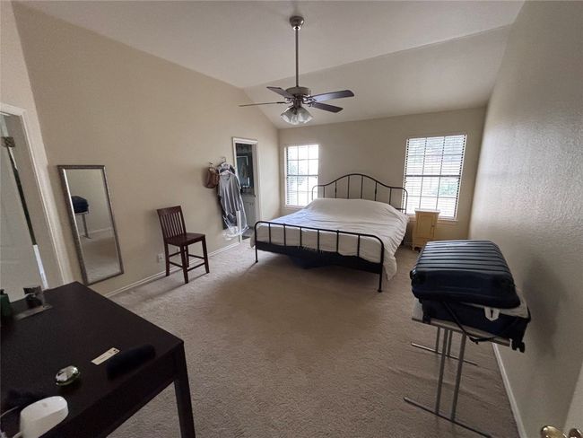 Bedroom featuring carpet flooring, lofted ceiling, and a ceiling fan | Image 12