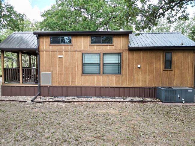 View of side of property featuring a metal roof and a central air condition unit | Image 15