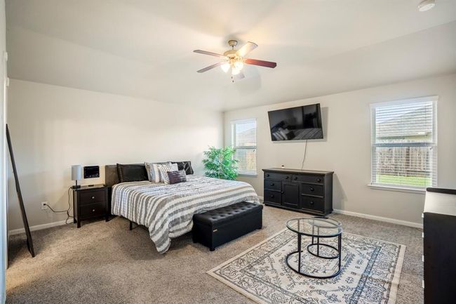 The large primary bedroom has two large windows and offers lots of light. | Image 21