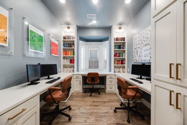 Home office featuring built in desk, light wood-type flooring, and recessed lighting | Image 20