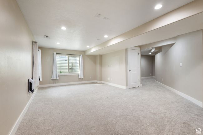 Basement with light colored carpet, recessed lighting, and heating unit | Image 26