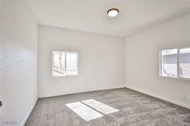 Carpeted spare room with healthy amount of natural light | Image 17