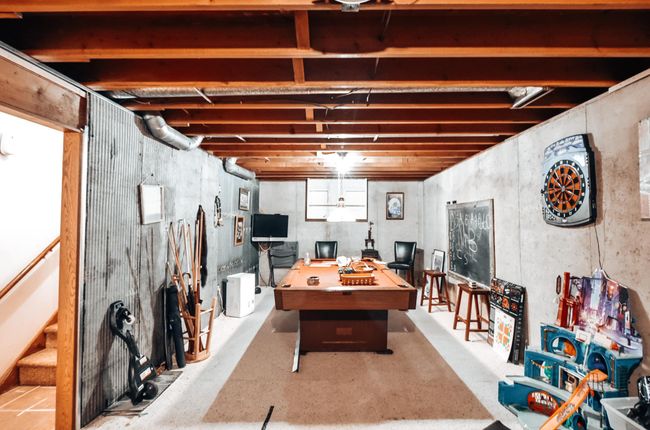 Lower level family room. You will notice to the left are the steps to bring you back upstairs which is right by the garage door. | Image 22