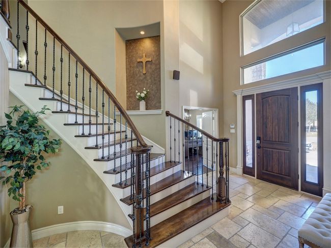 Entrance with curved staircase and wrought iron banister | Image 4