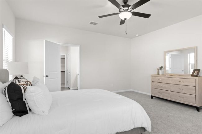 Bedroom with baseboards, visible vents, a ceiling fan, and light colored carpet | Image 21