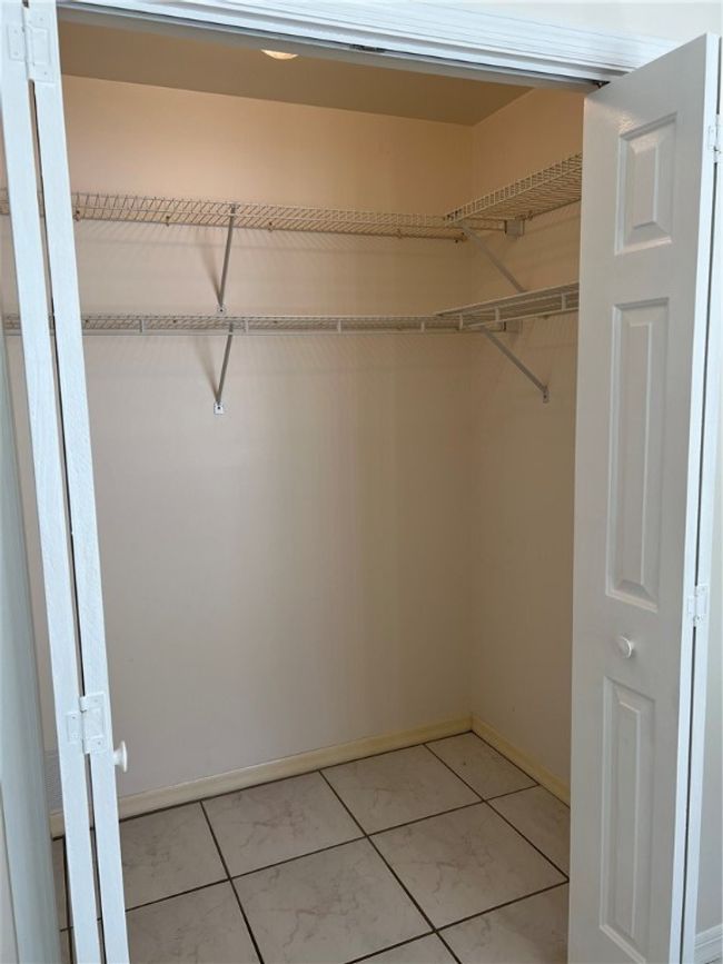 Guest bedroom walk in closet. | Image 25