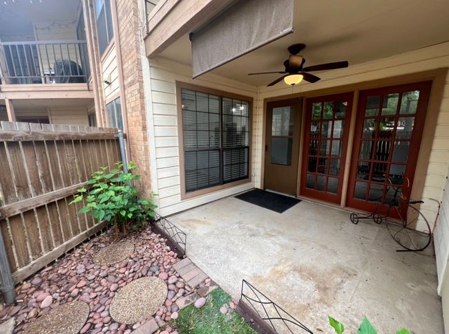 Property entrance with fence, ceiling fan, french doors, and a patio area | Image 23