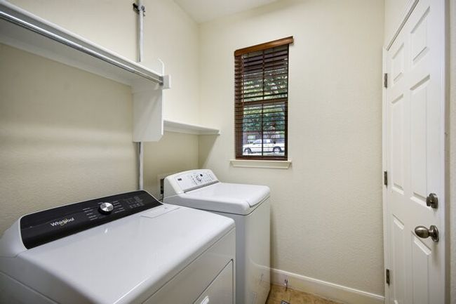 Washroom with baseboards and washing machine and clothes dryer | Image 17