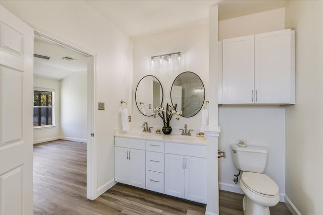 Both baths have been updated with sleek modern mirrors, faucets and fixtures. | Image 4
