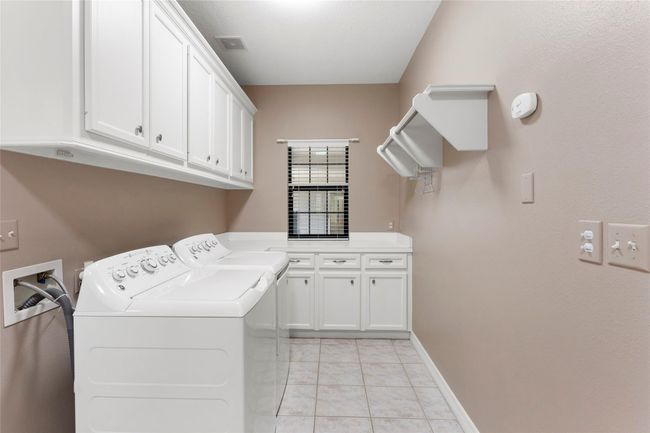 Utility room with tons of cabinet storage. | Image 25