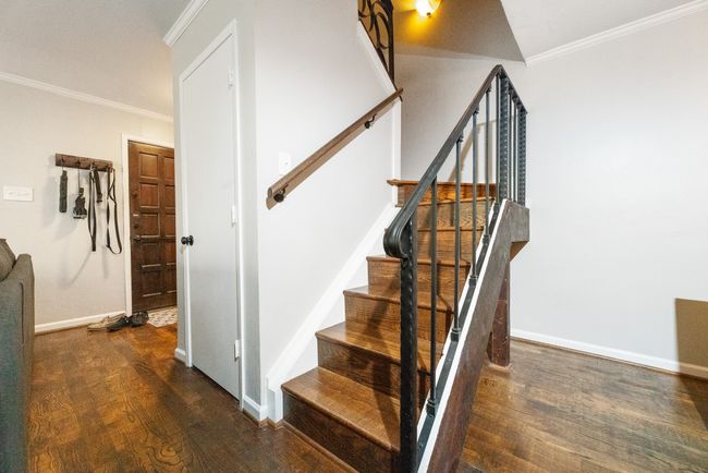 Stairway with wood finished floors, crown molding, and baseboards | Image 10