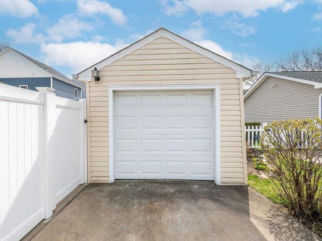Detached garage with aphalt driveway and fence | Image 13