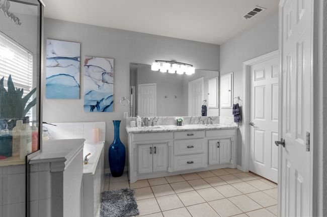 Bathroom featuring tile patterned floors, visible vents, a sink, and double vanity | Image 19