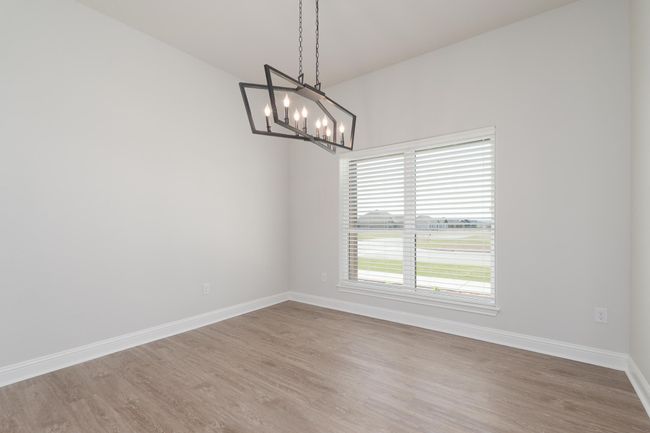 Dining Roomh baseboards, an inviting chandelier, and wood finished floors | Image 15