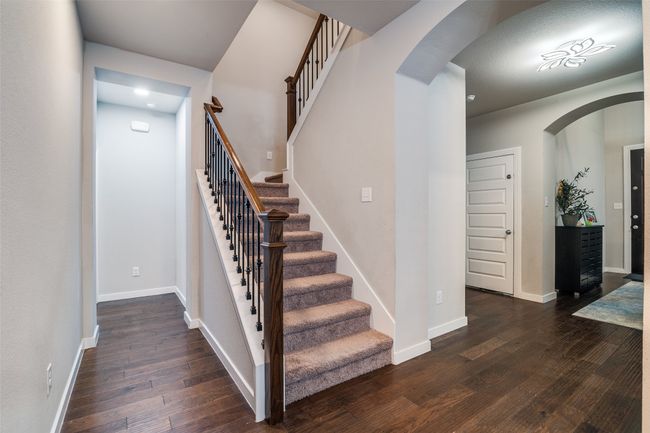 Stairway with wood-type flooring and arched walkways | Image 6