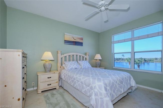 Bedroom featuring ceiling fan, light tile patterned floors, and a water view | Image 34