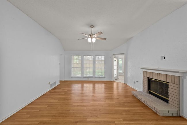 Living room featuring lofted ceiling & wall of windows overlooking the backyard | Image 6