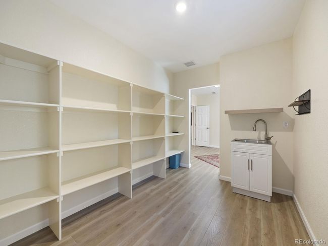 Bedroom/craft room closet with shelving & utility sink | Image 26