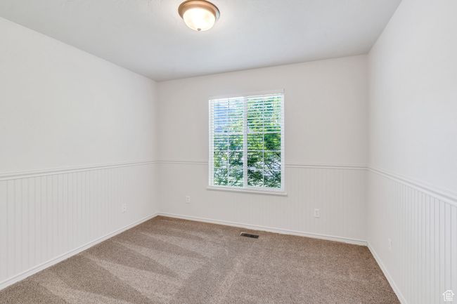 Carpeted empty room featuring wainscoting | Image 14