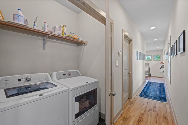 Laundry area with baseboards, laundry area, washing machine and clothes dryer, recessed lighting, and light wood-style flooring | Image 23