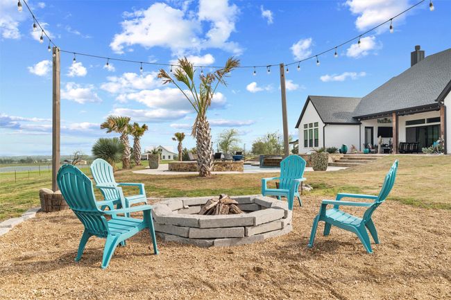 View of yard with an outdoor fire pit and a patio area | Image 24