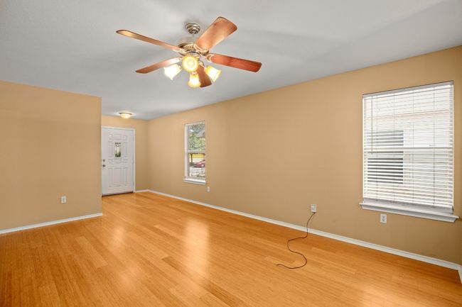 Spare room featuring light wood-style floors, ceiling fan, and baseboards | Image 4