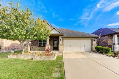 If you're looking for a home that stands out from the rest, you've found it! Begin your journey through the home with a beautiful entrance surrounded by an impressive landscape. | Image 2