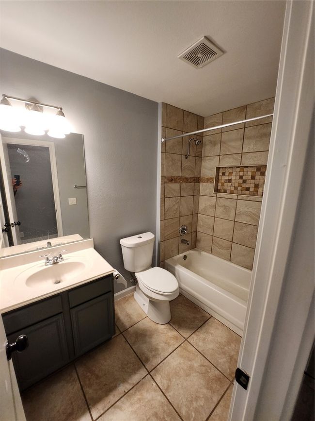 Bathroom featuring vanity, tile patterned floors, and bathing tub / shower combination | Image 12