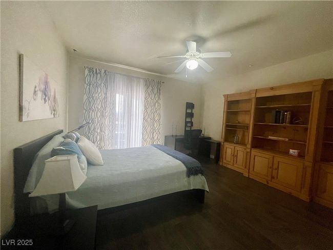 Bedroom featuring dark wood-style flooring and ceiling fan | Image 34