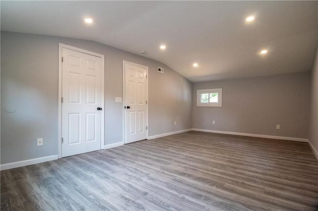 Unfurnished room with lofted ceiling and hardwood / wood-style floors | Image 8