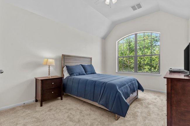 A cheerful laundry space with room to fold, sort, and store—made better with natural light and built-in shelving. | Image 33