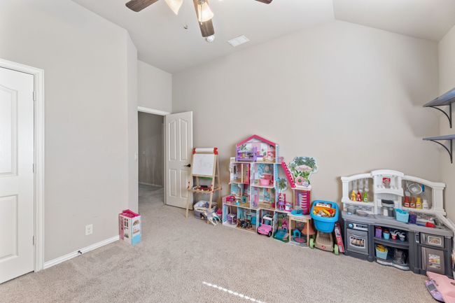 Unfurnished bedroom featuring dark wood-style floors, lofted ceiling, and baseboards | Image 21