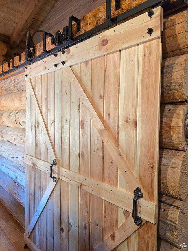 Details featuring log walls and a barn door | Image 91