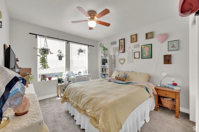 Bedroom featuring light carpet and ceiling fan | Image 24
