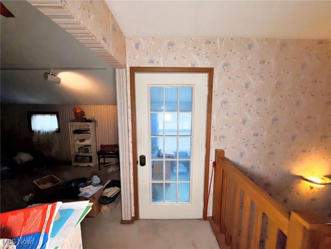 Doorway to outside featuring wallpapered walls | Image 10
