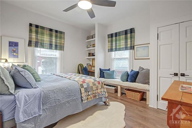 Second Bedroom with closet built in desk, shelves and window seat and ceiling fan | Image 18