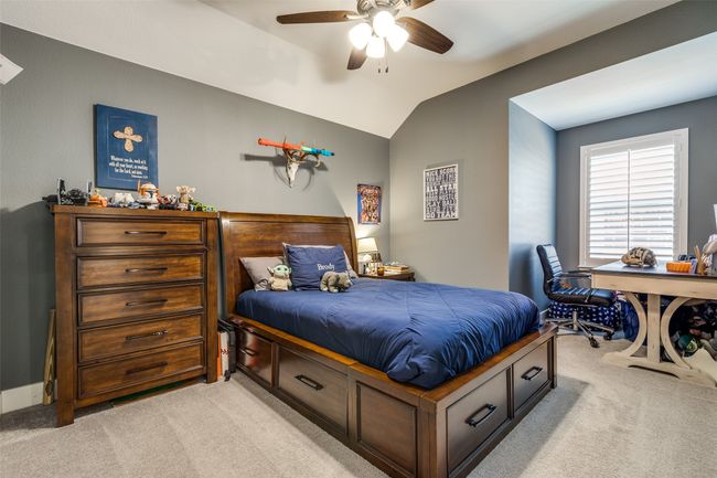 Bedroom with ceiling fan, light carpet, and vaulted ceiling | Image 13