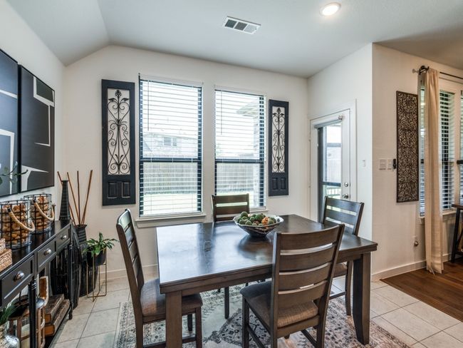 Dining area featuring baseboards, lofted ceiling, visible vents, and light tile patterned floors | Image 19