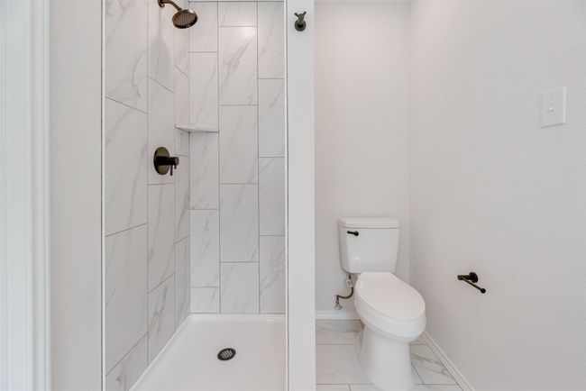 Full bathroom featuring tiled shower | Image 15