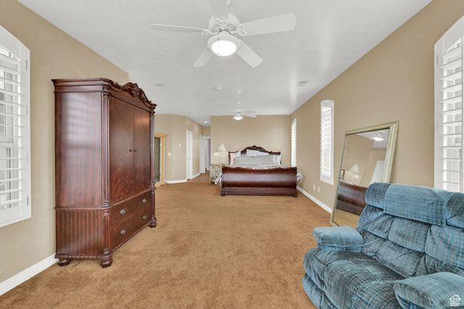 Bedroom with ceiling fan, light carpet, and baseboards | Image 30