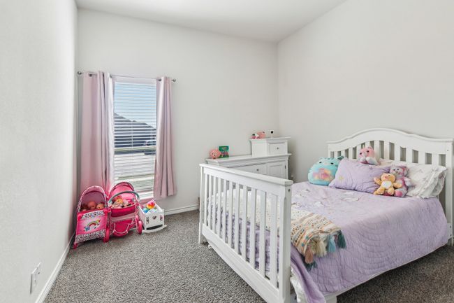 Carpeted bedroom featuring baseboards | Image 22
