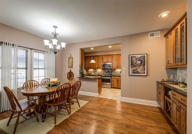 Dining area with a chandelier, light wood-style floors, and recessed lighting | Image 10