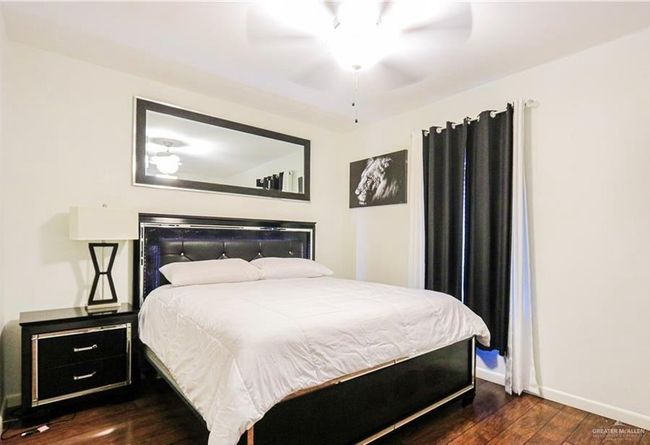 Bedroom featuring ceiling fan and dark hardwood / wood-style flooring | Image 12